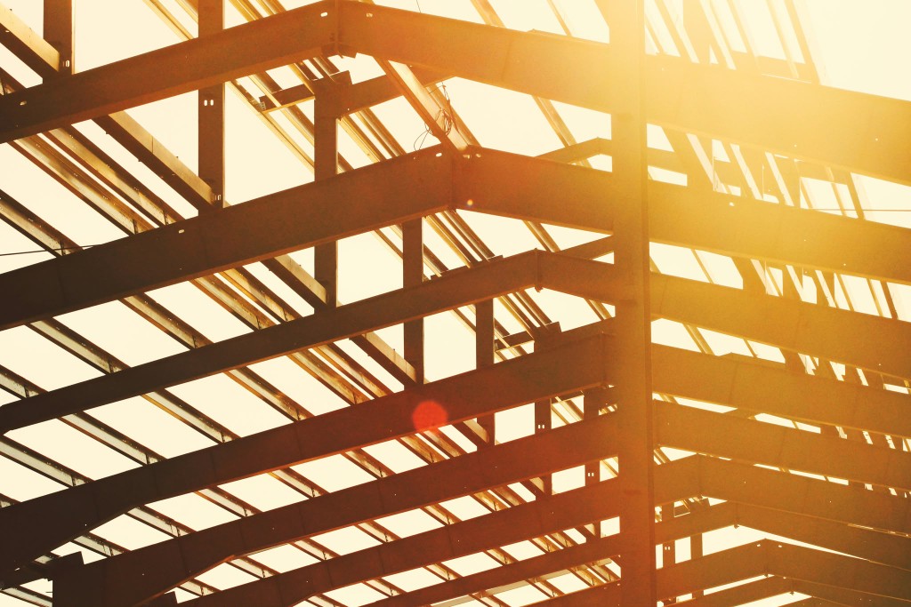 Structural steel framework under warm sunset light