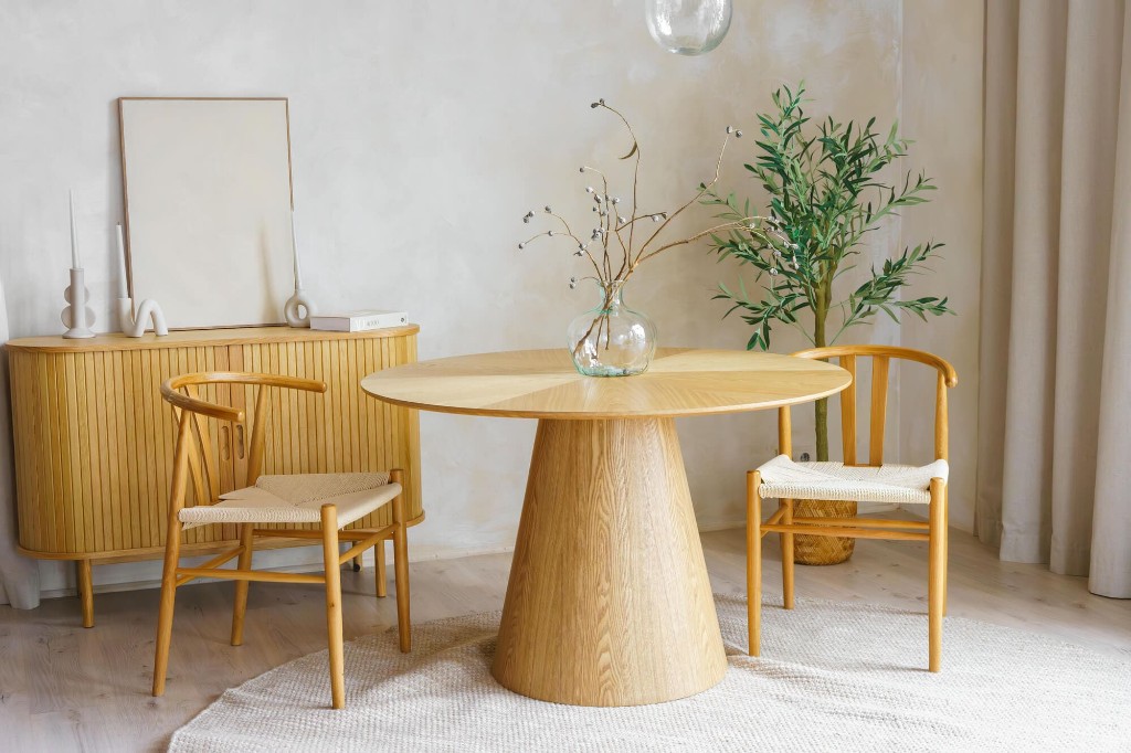 Minimal dining space with sculpted wood table and custom cabinetry